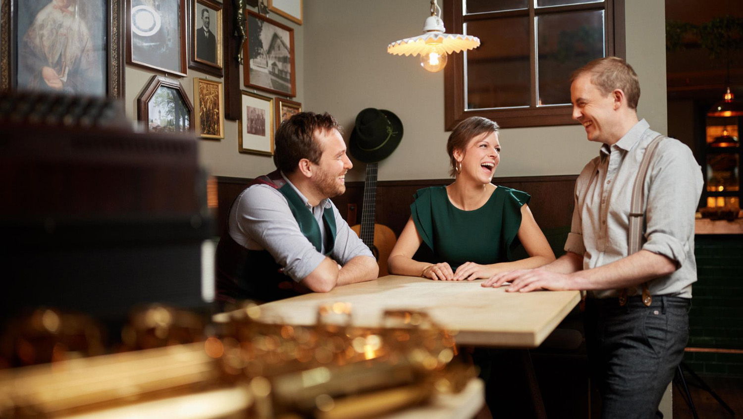 picture of the band grossstadt boazn sitting at a restaurant table
